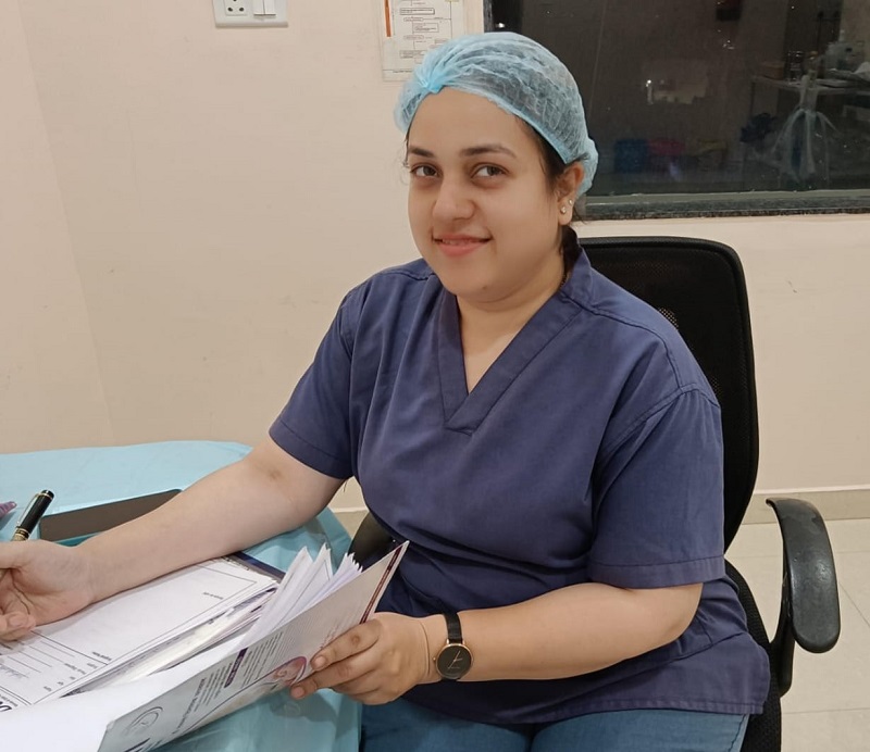 "Dr. Tamanna Vinaik Agrawal at Tamanna Woman & Child Clinic, smiling while holding medical documents."